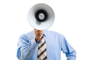 Image of man standing in front of camera and speaking into megaphone